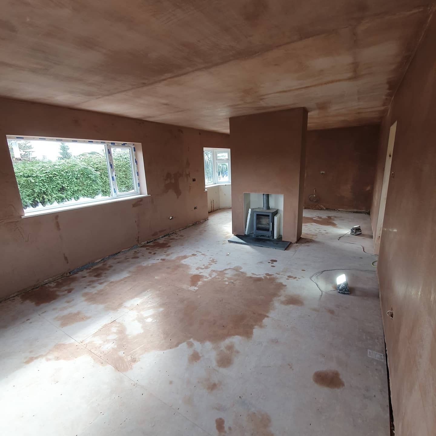 Freshly skimmed open-plan living room with new plaster on walls and ceiling