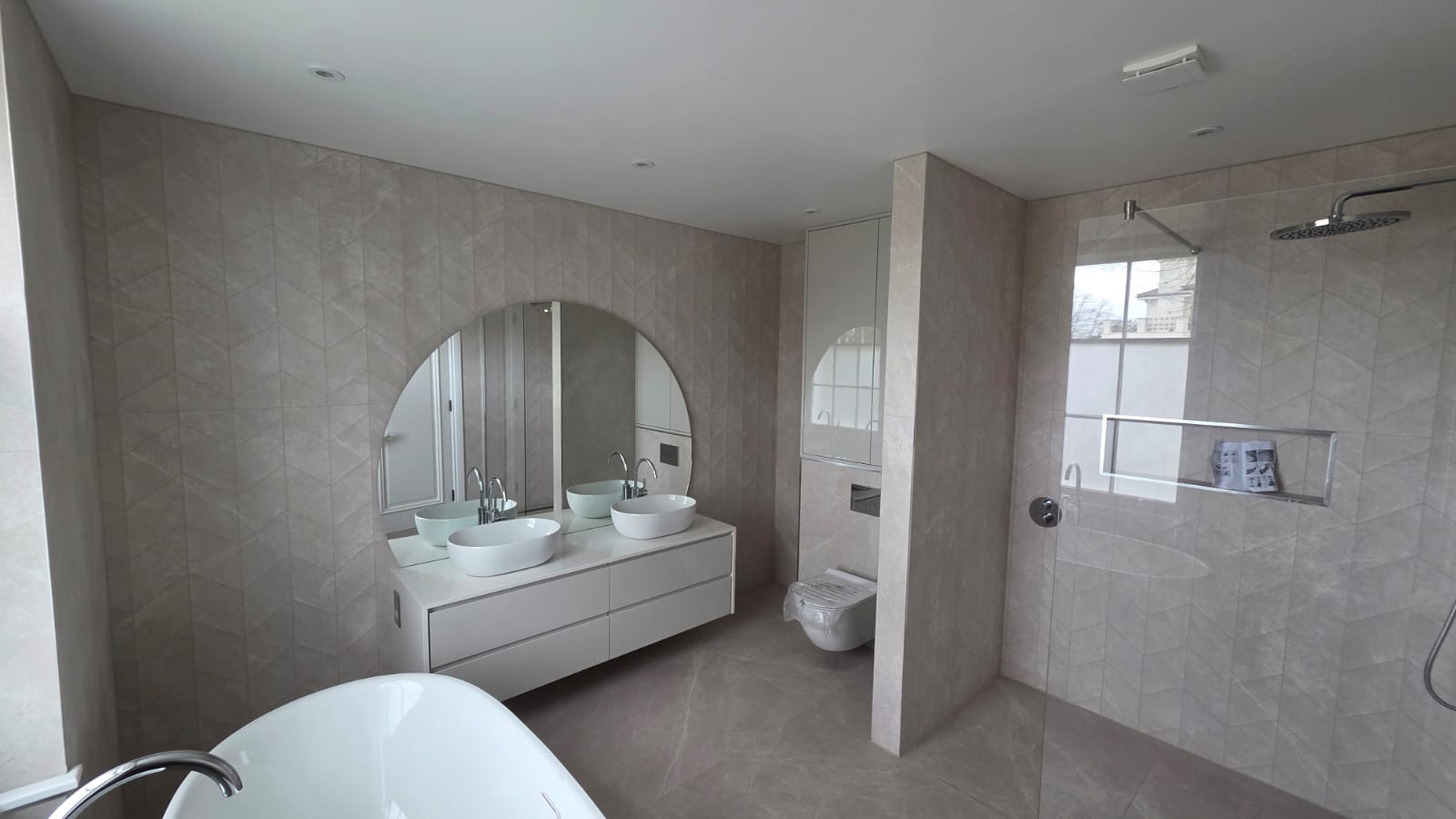 Modern family bathroom with double vanity and freestanding tub