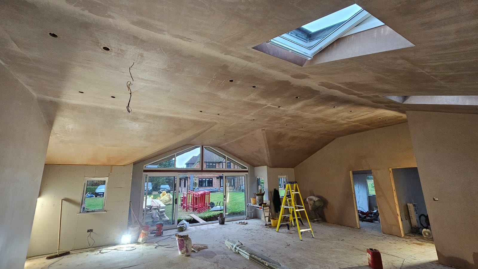 Freshly over-boarded and skimmed vaulted ceiling with skylight, replacing old textured artex